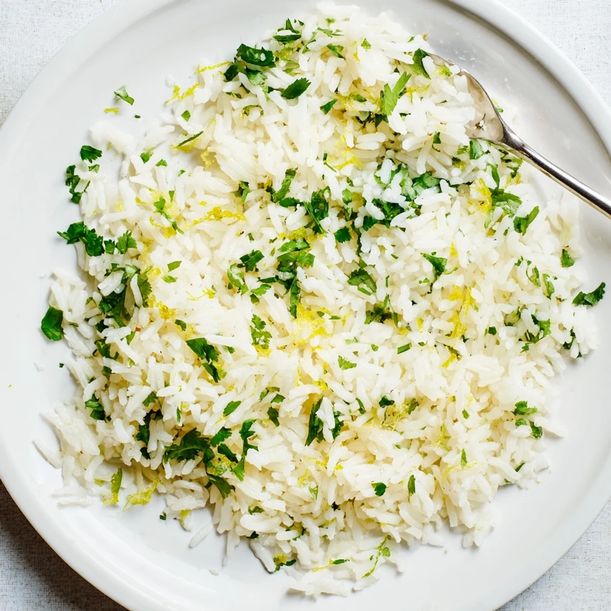 Fluffy cilantro lime rice, garnished with fresh cilantro and a squeeze of lime juice.