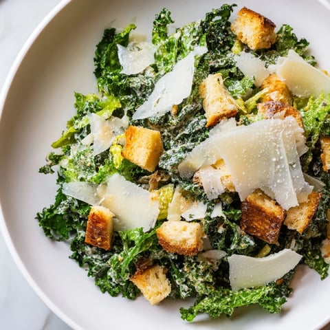 Hearty Kale Caesar Salad, featuring vibrant green kale, Parmesan, and golden, crunchy croutons.