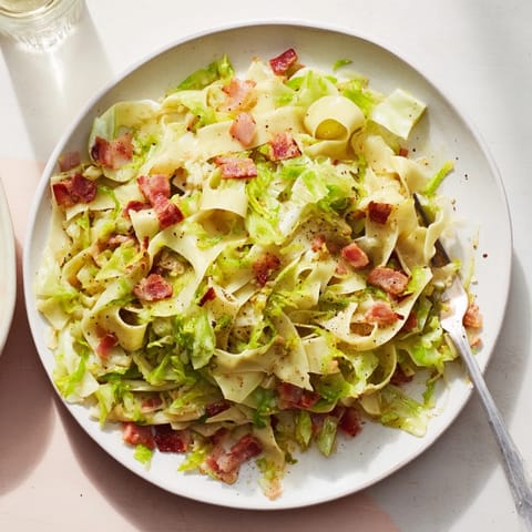 Sizzling bacon and caramelized cabbage enhance the flavors of this German Fried Bacon Cabbage Noodles recipe.