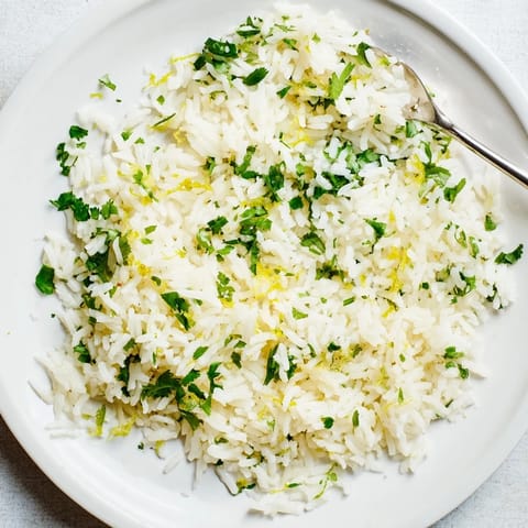 Fluffy cilantro lime rice, garnished with fresh cilantro and a squeeze of lime juice.